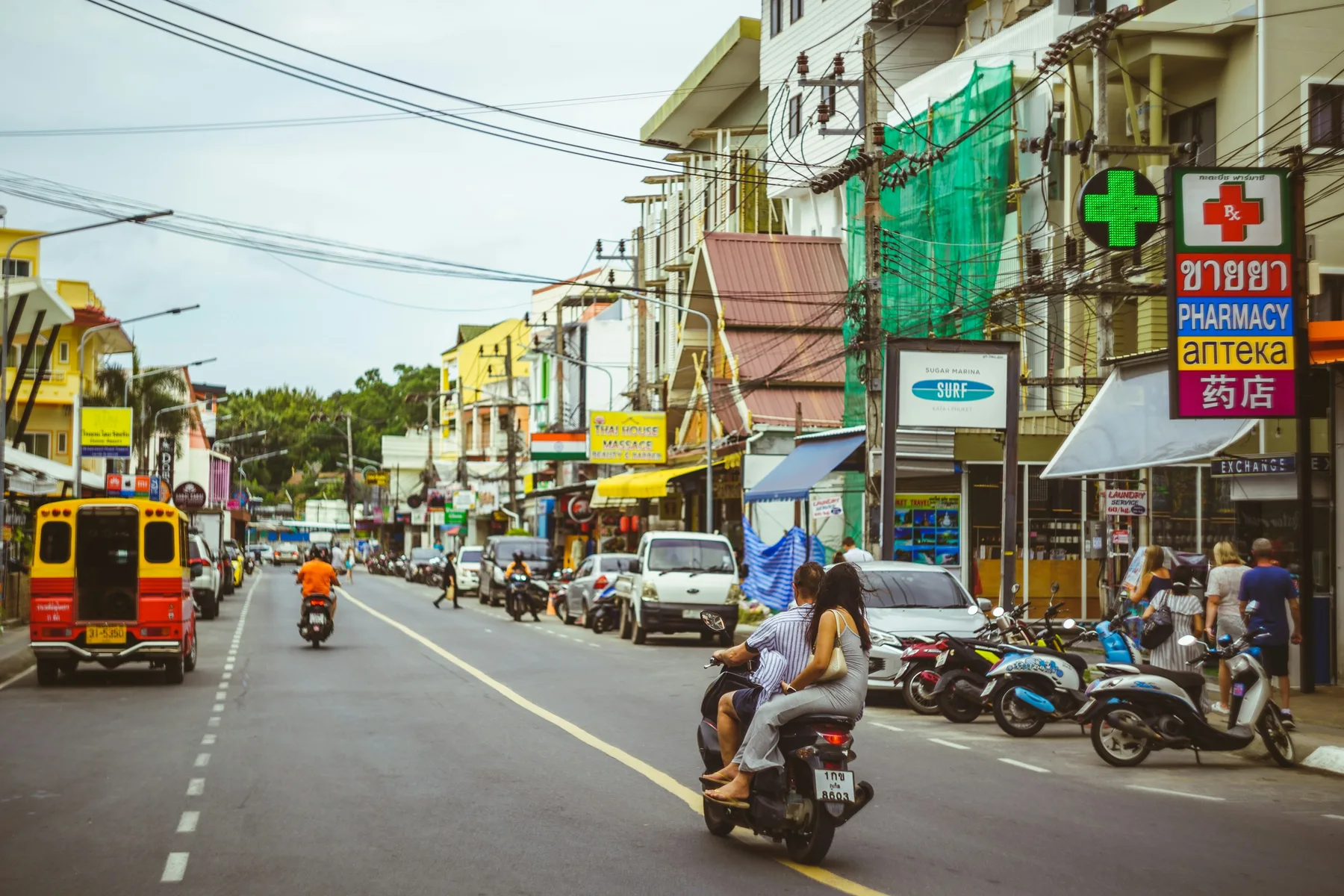 Scooters and colourful shophouses on a Phuket street; illustrative destination photograph